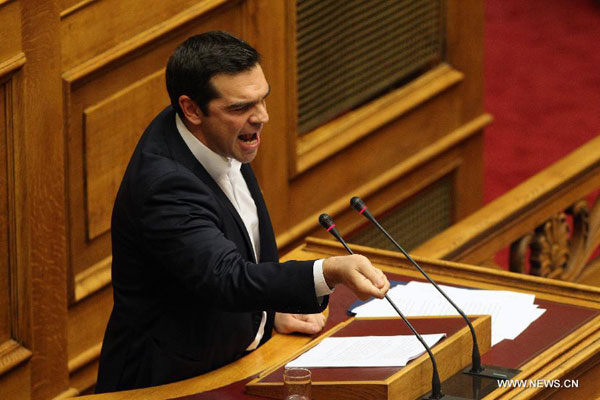 Greek Prime Minister Alexis Tsipras addresses Parliament on government policy statements in Athens, Greece, on Oct. 5, 2015. Greek Prime Minister Alexis Tsipras presented his Left-led government's four-year policy program on Monday, pledging full and swift implementation of reforms and commitments undertaken under the third bailout agreed with international lenders this summer. [Xinhua]