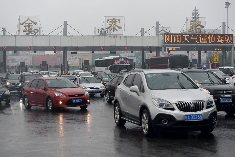 Cars move out of the Jinzhailu exit of an expressway in Hefei, capital of east China's Anhui Province, Oct. 7, 2015. A travel peak is seen around China on Wednesday, the last day of the seven-day National Day holidays. [Xinhua]