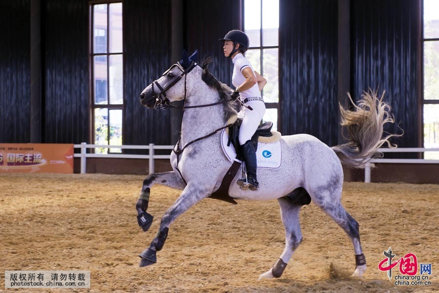 Tian Yu, just out of her teens, is among a small handful of professional equestriennes in China who have to spend a lot of time on horseback. [Photo by Lan Yang/China.org.cn]