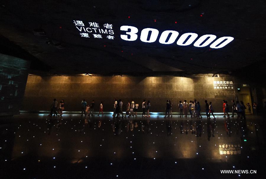People view a wall with victims' names for the Nanjing Massacre in 1937 at the Memorial Hall of the Victims in Nanjing Massacre by Japanese Invaders in Nanjing, capital of east China's Jiangsu Province, Aug. 15, 2015. Documents of the Nanjing Massacre from China were inscribed on the Memory of the World Register by the International Advisory Committee of UNESCO's Memory of the World Programme, UNESCO announced on Oct. 9 in a press release. [Xinhua]