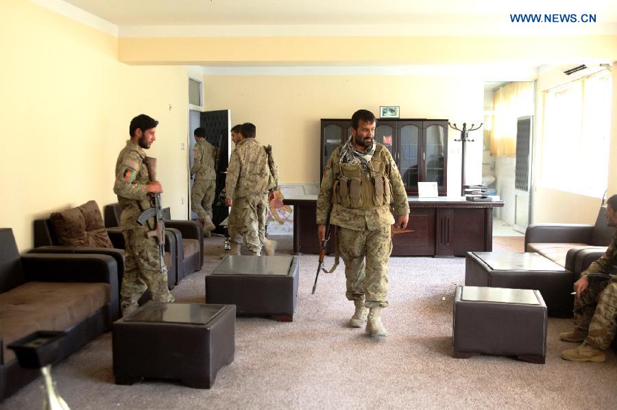 Policemen walk inside the room of a government building after Taliban militants burnt it down in Kunduz city, Afghanistan, Oct. 9, 2015. Fierce clashes erupted between the security forces and Taliban insurgents Friday night on the southern outskirts of Kunduz city, capital of Afghanistan's northern province of Kunduz, police said. [Xinhua]