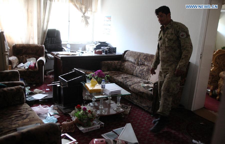 A policeman is seen in a destroyed room of a government building after Taliban militants burnt it down in Kunduz city, Afghanistan, Oct. 9, 2015. Fierce clashes erupted between the security forces and Taliban insurgents Friday night on the southern outskirts of Kunduz city, capital of Afghanistan's northern province of Kunduz, police said. [Xinhua]