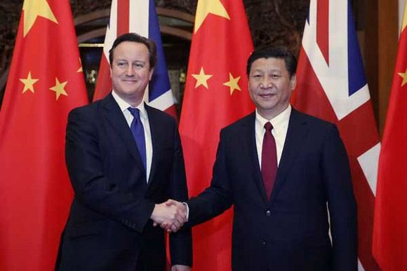 President Xi Jinping shakes hands with visiting British Prime Minister David Cameron in Beijing, Dec 2, 2013. [Photo/Xinhua]