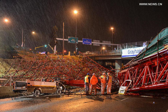 Photo taken on Oct. 14, 2015 shows the scene of a collapsed bridge in Johannesburg, South Africa. Two people were killed and 23 others injured as the bridge, which is still under construction, collapsed on a main motorway in Johannesburg on Wednesday. [Photo/Xinhua]