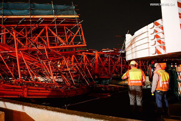 Photo taken on Oct. 14, 2015 shows the scene of a collapsed bridge in Johannesburg, South Africa. Two people were killed and 23 others injured as the bridge, which is still under construction, collapsed on a main motorway in Johannesburg on Wednesday. [Photo/Xinhua]