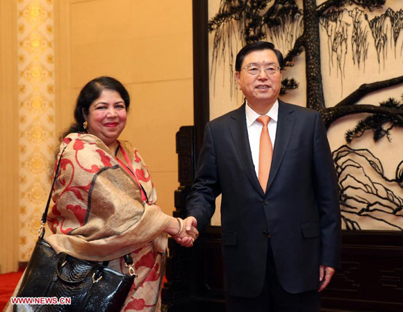 Zhang Dejiang, chairman of the Standing Committee of the National People's Congress, shakes hands with Speaker of the Bangladesh National Assembly Shirin Sharmin Chowdhury at the Great Hall of the People in Beijing, China, Oct. 15, 2015. [Photo/Xinhua]