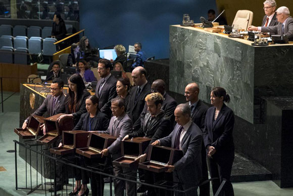 Conference officers hold up empty ballot boxes for inspection prior to the vote to elect five non-permanent members of the Security Council. [UN Photo] 
