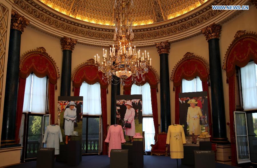 Photo taken on Sept. 7, 2015 shows dresses worn by Britain's Queen Elizabeh II on display at the Buckingham Palace in London, capital of Britain. The Buckingham Palace has served as the official London residence of Britain's sovereigns since 1837 and today is the administrative headquarters of the Monarch. [Xinhua]