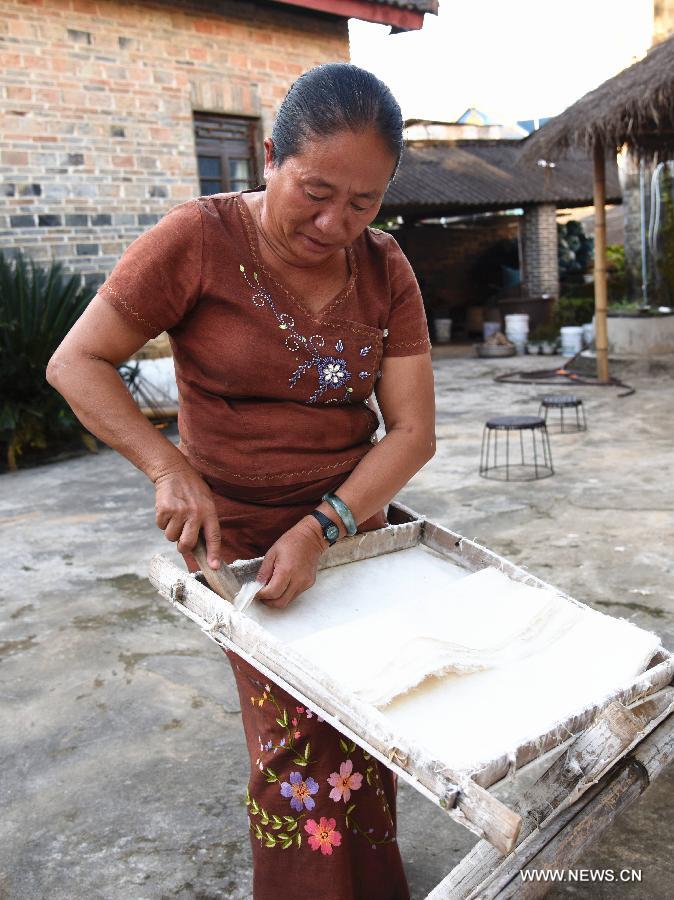 A woman is busy with paper making in Mangtuan Village of Gengma Dai and Wa Autonomous County, southwest China's Yunnan Province, Oct. 15, 2015. The time-honored Dai people's paper-making skill, with a history of several centuries, is mainly mastered by local women and was listed as a national intangible cultural heritage in 2006. Local villagers see it as a key money spinner. [Xinhua]