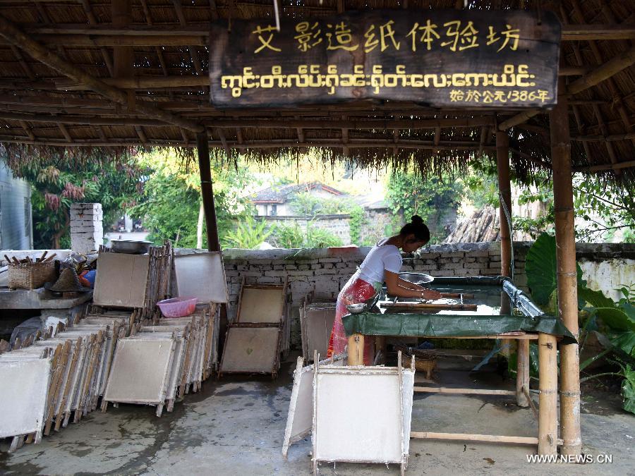 Ai Ying works at her family's paper-making workshop in Mangtuan Village of Gengma Dai and Wa Autonomous County, southwest China's Yunnan Province, Oct. 15, 2015. The time-honored Dai people's paper-making skill, with a history of several centuries, is mainly mastered by local women and was listed as a national intangible cultural heritage in 2006. Local villagers see it as a key money spinner. [Xinhua]