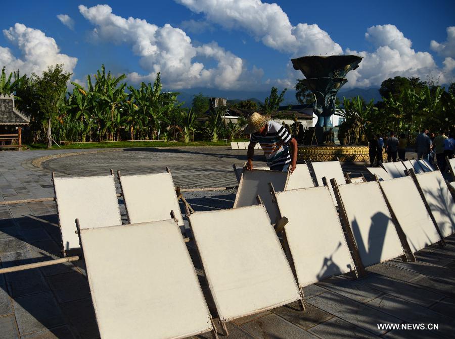 A man puts hand-made mulberry bark paper to a courtyard for drying at Mangtuan Village of Gengma Dai and Wa Autonomous County, southwest China's Yunnan Province, Oct. 15, 2015. This time-honored paper-making skill, with a history of several centuries, is mainly mastered by local women of the Dai ethnic group, and has been listed as the national intangible cultural heritage in 2006. Local villagers see it as a key money spinner. [Xinhua]