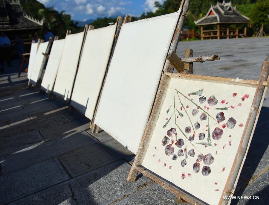 Photo taken on Oct. 15, 2015 shows hand-made mulberry bark paper dried at Mangtuan Village of Gengma Dai and Wa Autonomous County, southwest China's Yunnan Province. The time-honored Dai people's paper-making skill, with a history of several centuries, is mainly mastered by local women and was listed as a national intangible cultural heritage in 2006. Local villagers see it as a key money spinner. [Xinhua]