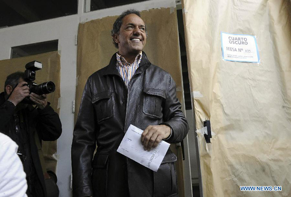 Presidential candidate Daniel Scioli of the ruling Front for Victory Party reacts after casting his ballot during the general elections at a polling station in Dique Lujan, 50km from Buenos Aires city, Argentina, on Oct. 25, 2015. [Photo/Xinhua]