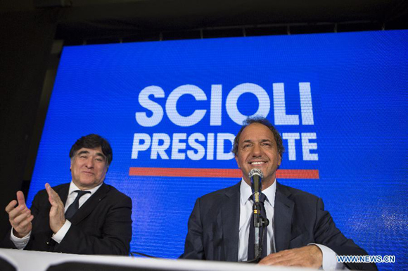 Argentina's ruling party Victory Front's presidential candidate Daniel Scioli (R) takes part in a press conference, accompanied by his vice presidential candidate Carlos Zanini, in Buenos Aires, Argentina, on Oct. 26, 2015. [Photo/Xinhua] 