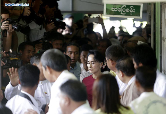 Chairperson of the National League for Democracy (NLD) Aung San Suu Kyi (C) arrives to cast her vote during the general elections at a polling station in Yangon, Myanmar, Nov. 8, 2015. [Photo/Xinhua]