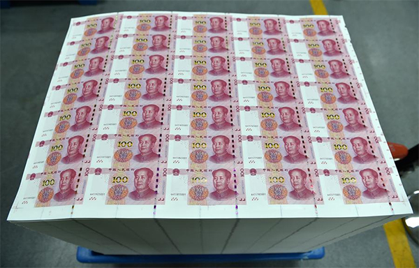 New 100-yuan notes wheeled out in the factory of China Banknote Printing and Minting Corporation, Oct 29. [Photo/Xinhua]