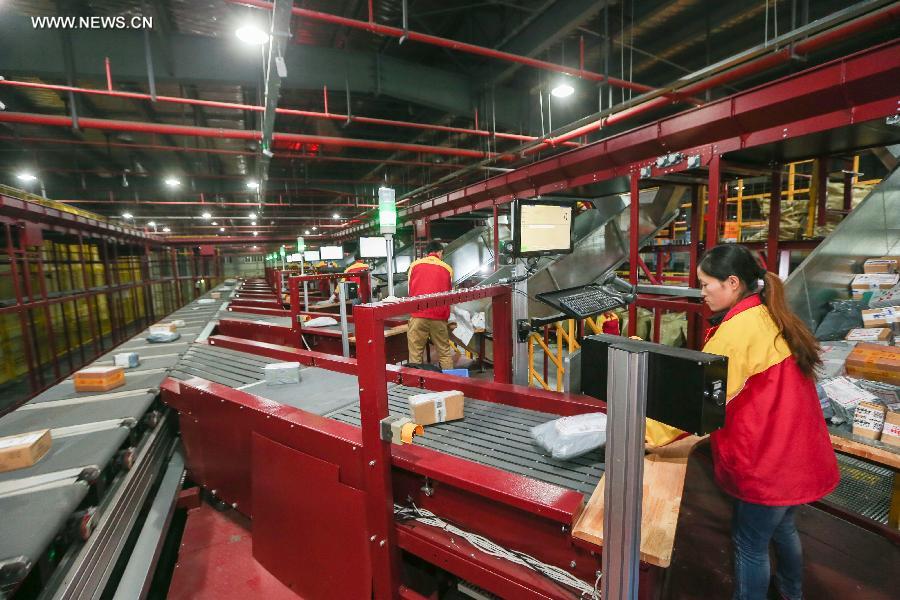 Workers sort out packages at a sorting center in Shanghai, east China, Nov. 11, 2015. The Singles' Day Shopping Spree, or Double-11 Shopping Spree, Chinese equivalent of Cyber Monday or Black Friday, is an annual online shopping spree falling on Nov. 11 for Chinese consumers since 2009. Each year the express delivery industry will face package peak after the shopping spree. [Xinhua]