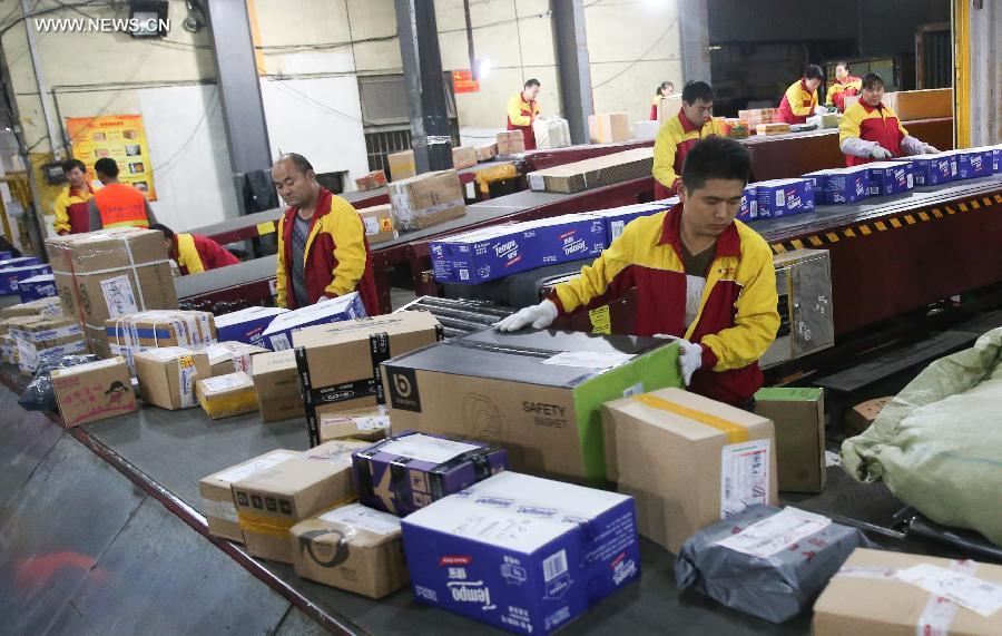 Workers sort out packages at a sorting center in Shanghai, east China, Nov. 11, 2015. The Singles' Day Shopping Spree, or Double-11 Shopping Spree, Chinese equivalent of Cyber Monday or Black Friday, is an annual online shopping spree falling on Nov. 11 for Chinese consumers since 2009. Each year the express delivery industry will face package peak after the shopping spree. [Xinhua]