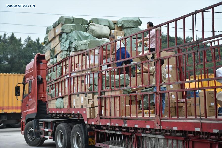 Workers sort out packages at a sorting center in Guangzhou, capital of south China's Guangdong Province, Nov. 11, 2015. The Singles' Day Shopping Spree, or Double-11 Shopping Spree, Chinese equivalent of Cyber Monday or Black Friday, is an annual online shopping spree falling on Nov. 11 for Chinese consumers since 2009. Each year the express delivery industry will face package peak after the shopping spree. [Xinhua]