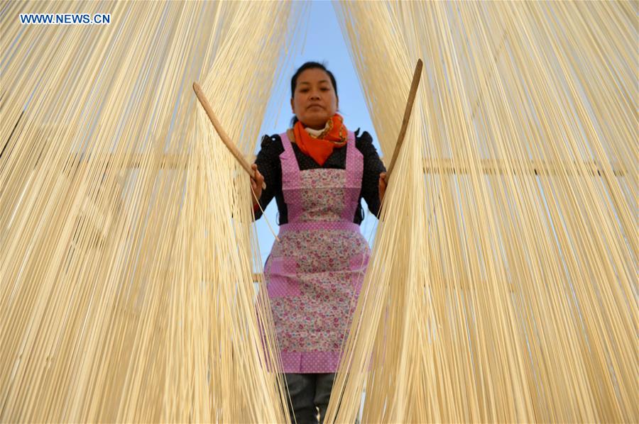 A villager separates vermicelli in Linze Village, Huaian City of east China's Jiangsu Province, Nov. 12, 2015. Linze Village, long famous for its handmade vermicelli, has passed on the traditional handicraft for about one hundred years. [Xinhua]