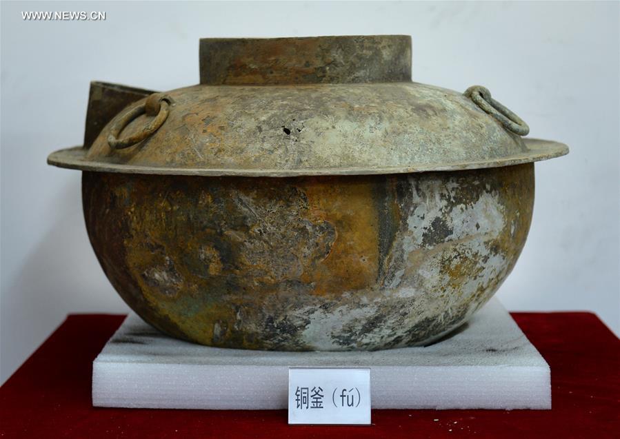 Photo taken on Nov. 6, 2015 shows a bronze kettle unearthed from the excavation site of royal tombs of Marquis of Haihun State during the West Han Dynasty (206 B.C.--25 A.D.) in Nanchang, capital of east China's Jiangxi Province. 