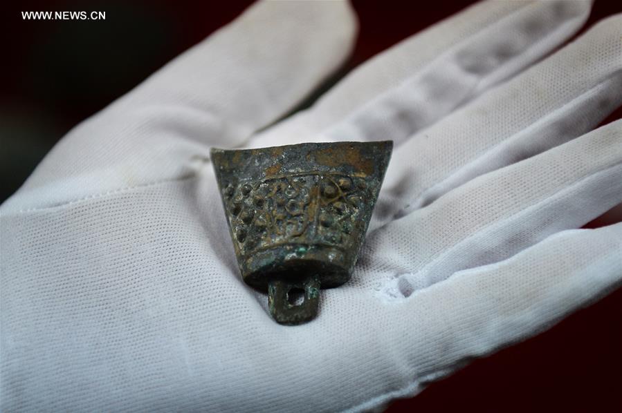 Photo taken on Nov. 6, 2015 shows a piece of bronze ware unearthed from the excavation site of royal tombs of Marquis of Haihun State during the West Han Dynasty (206 B.C.--25 A.D.) in Nanchang, capital of east China's Jiangxi Province. 