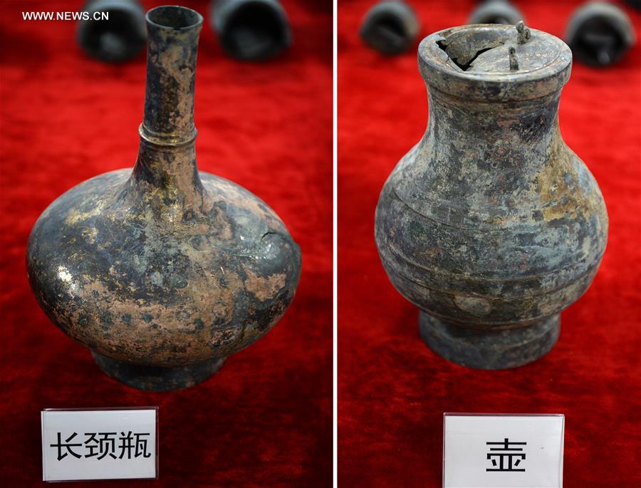 Combined photos taken on Nov. 6, 2015 shows bronze ware unearthed from the excavation site of royal tombs of Marquis of Haihun State during the West Han Dynasty (206 B.C.--25 A.D.) in Nanchang, capital of east China's Jiangxi Province.