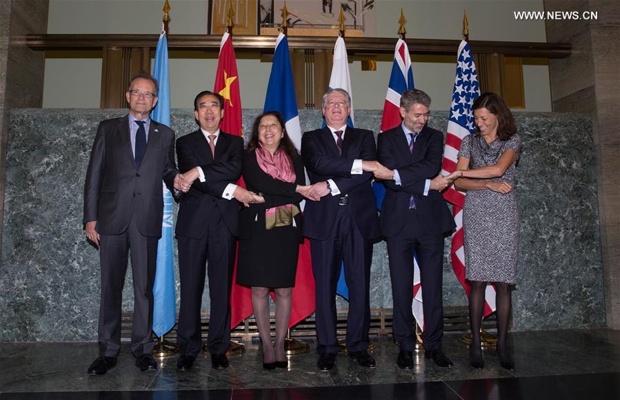 Representatives in Geneva of the five permanent members of UN Security Council, namely, (R to L) Pamela Hamamoto of the United States, Julian Braithwaite of the United Kingdom, Alexey Borodavkin of Russia, Elisabeth Laurin of France and Wu Hailong of China, and Director-General of the United Nations Office (1st, L) at Geneva (UNOG) Michael Moller pose for photos before a joint concert in Palais des Nations in Geneva, Switzerland, Nov. 12, 2015.