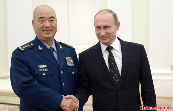 Russia's President Vladimir Putin (R) and Xu Qiliang, vice chairman of China's Central Military Commission, shake hands during a meeting at Moscow's Kremlin on November 17, 2015. [Photo/China.org.cn]