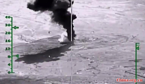 The video screen grab shows aircrafts of the Russian Aerospace Forces carry out an airstrike against oil extraction, storage and refining facilities controlled by the Islamic State in Syria, Nov. 23, 2015. [Photo/China.org.cn]