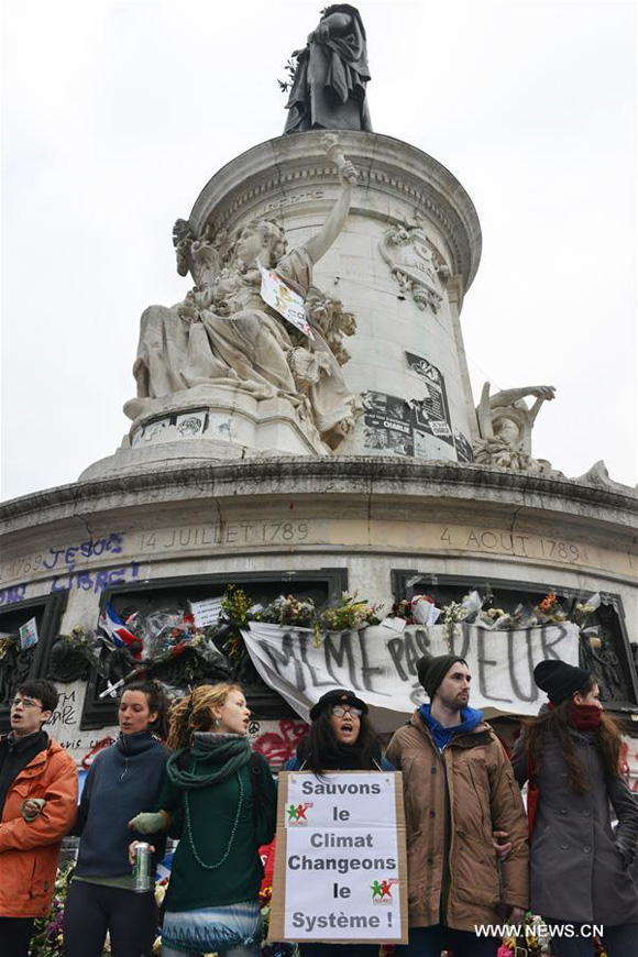 Protestors stand at the Parisian square, La Place de La Republique, before the start of the Paris Climate Change Conference (COP21) in Paris, France, on Nov. 29, 2015. [Photo/Xinhua]