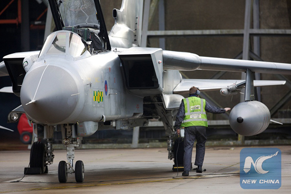 Pilots and ground crew prepare a Tornado GR4 aircraft at the British Royal Air Force airbase RAF Marham in Norfolk in east England on December 2, 2015 [Photo/Xinhua]