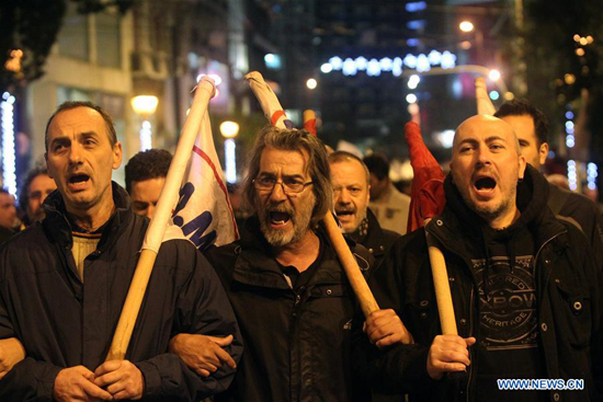 Supporters of the communist-affiliated union PAME shout slogans during an anti-austerity rally in Athens, Greece, on Dec. 15, 2015. [Photo/Xinhua]