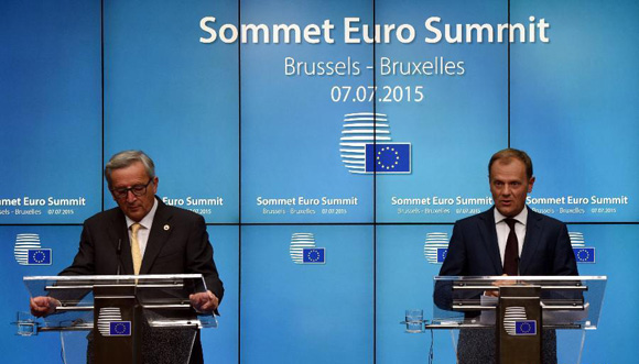 European Council President Donald Tusk (R) and European Commission President Jean-Claude Juncker participate in a press conference following a euro zone leaders summit in Brussels, Belgium, July 7, 2015. [Photo/Xinhua]