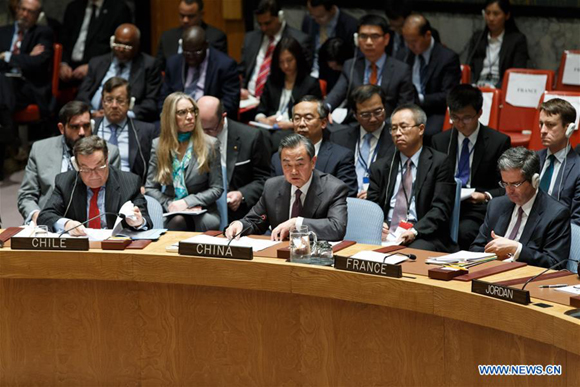 Chinese Foreign Minister Wang Yi (C, front) speaks during a United Nations Security Council meeting on Syria at the UN headquarters in New York, Dec. 18, 2015. The UN Security Council on Friday adopted a resolution endorsing an international roadmap for a Syrian-led political transition in order to end the country's conflict, which calls for Syria peace talks to begin in early January.