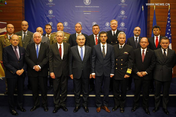 Romanian and U.S. officials pose for a group photo during a ceremony at Romania's Foreign Ministry headquarters in Bucharest, Romania's capital, Dec. 18, 2015. A U.S. missile shield in Romania's Deveselu military base is technically ready as a ceremony in the Romanian Foreign Ministry on Friday marks its completion.