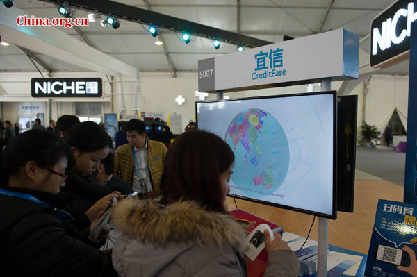 Visitors to the Light of the Internet Exposition check CreditEase's pavilion on Dec. 18, 2015 during the 2nd WIC held in Wuzhen, Zhejiang Province. [Photo by Chen Boyuan / China.org.cn] 