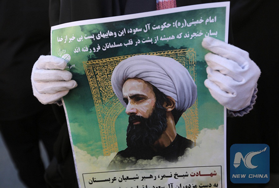 An Iranian woman holds a portrait of prominent Shiite Muslim cleric Nimr al-Nimr during a demonstration against his execution by Saudi authorities, on Jan. 3, 2016, outside the Saudi embassy in Tehran. [Photo/Xinhua]