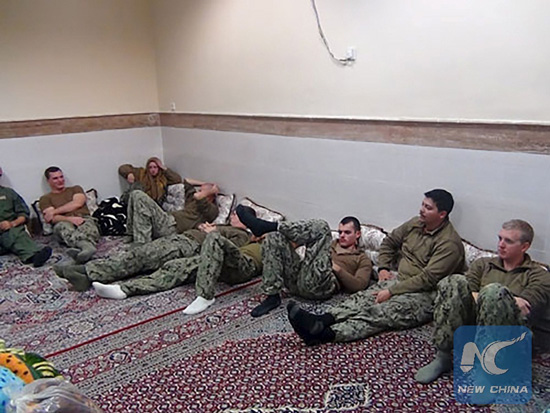 An undated picture released by Iran's Revolutionary Guards website shows American sailors sitting in a unknown place in Iran. [Photo/Xinhua]
