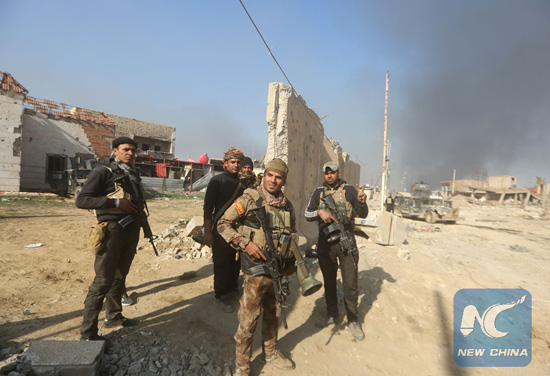 Members of Iraq's elite counter-terrorism service gather on Dec. 29, 2015 in the city of Ramadi, the capital of Iraq's Anbar province, about 110 kilometers west of Baghdad, after Iraqi forces recaptured it from the Islamic State (IS) jihadist group. [Photo/Xinhua]