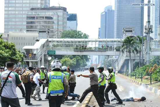 Policemen are seen at the explosion site in Jakarta, Indonesia, Jan. 14, 2016. [Photo/Xinhua]