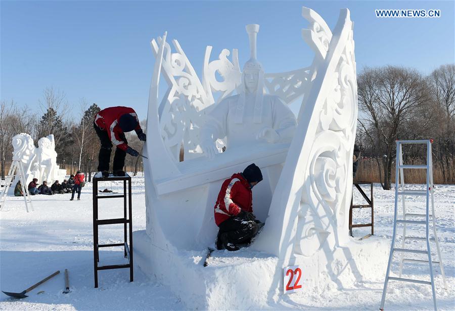 Mongolian contestants make a snow sculpture in Harbin, capital of northeast China's Heilongjiang Province, Jan. 13, 2016. The 21st Harbin International Snow Sculpture Contest ended here on Wednesday. [Xinhua]