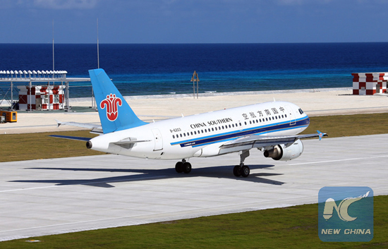 A civilian aircraft lands at the airfield on Yongshu Jiao in the Nansha Islands, Jan. 6, 2016. [Photo/Xinhua]