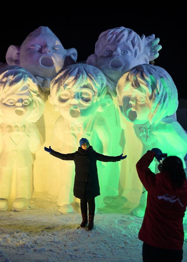 Tourists take pictures with snow sculptures on Changbai Mountain, northeast China&apos;s Jilin Province, Jan. 15, 2016. 