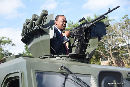Kenya's President Uhuru Kenyatta inspects a gun mounted armored vehicle at General Service Unit Headquarters in Nairobi, Kenya, Feb. 1, 2016. [Photo/Xinhua]