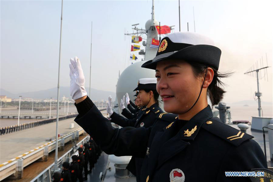 Navy crews wave at the bridge of destroyer Jinan as they return to a military port in Zhoushan, east China's Zhejiang Province, Feb. 5, 2016. 