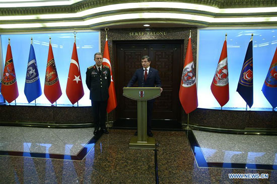 Turkish Prime Minister Ahmet Davutoglu (R) addresses a press conference in Turkish capital Ankara Feb. 18, 2016. [Photo/Xinhua] 