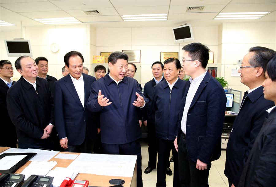 Chinese President Xi Jinping (C) talks with a correspondent who is just back from reporting in Zhengding County of Hebei Province, at the headquarters of Xinhua News Agency in Beijing, capital of China, on Feb. 19, 2016. Xi on Friday visited the People&apos;s Daily, Xinhua News Agency and China Central Television, the nation&apos;s three leading news providers.
