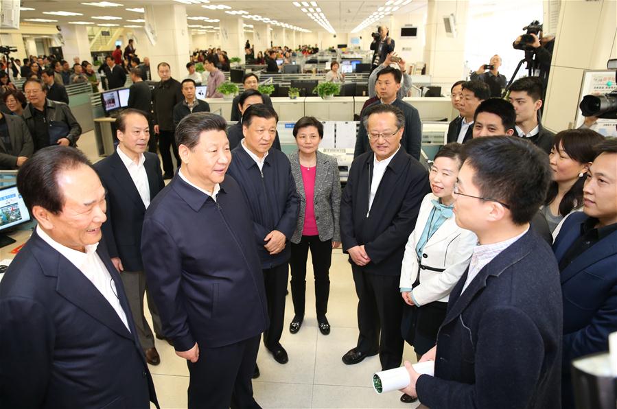 Chinese President Xi Jinping (2nd L, front) talks with a correspondent who is just back from reporting in Zhengding County of Hebei Province, at the headquarters of Xinhua News Agency in Beijing, capital of China, on Feb. 19, 2016. Xi on Friday visited the People&apos;s Daily, Xinhua News Agency and China Central Television, the nation&apos;s three leading news providers. 
