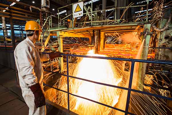 A worker at a steel company in Lianyungang, Jiangsu province, in January 2015. The steel sector will reduce capacity by 100 to 150 million metric tons in five years, according to China's top economic planner.[China Daily]